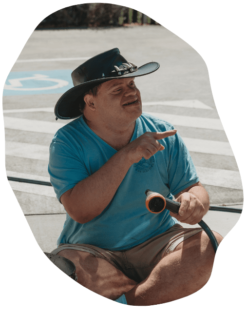 person with disability in a blue shirt wearing a hat