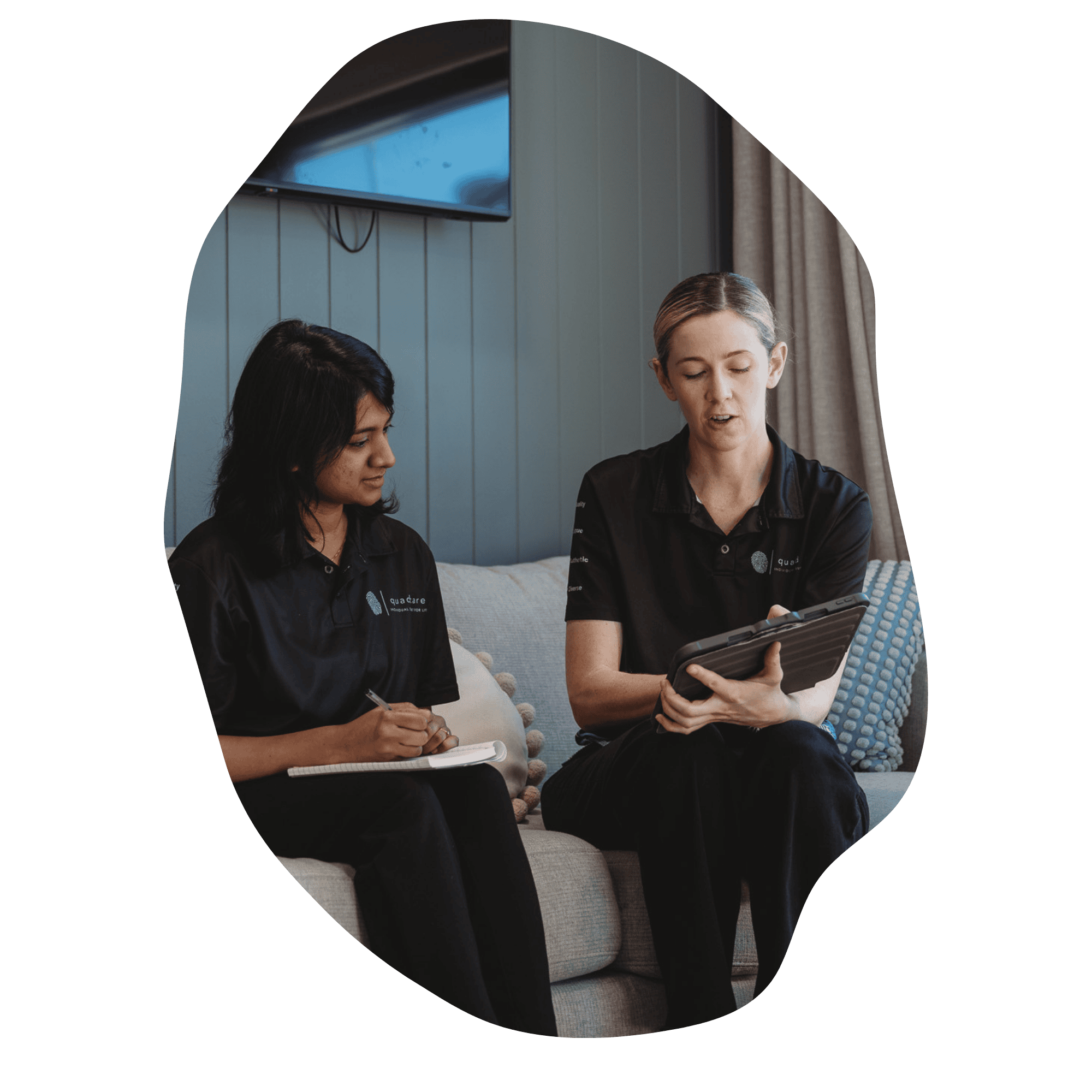Two occupational therapists discussing participant goals and therapy planning.